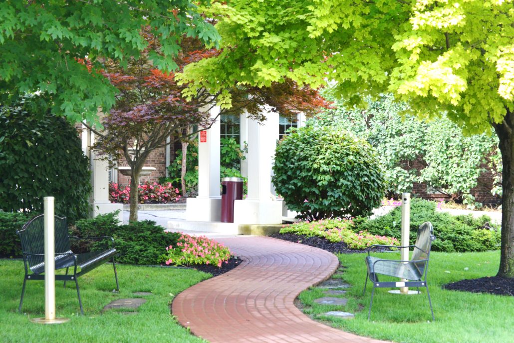 Brick Walkway lined with freshly planted flowers