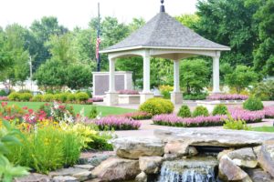 Walks lined with annuals, waterfall in foreground