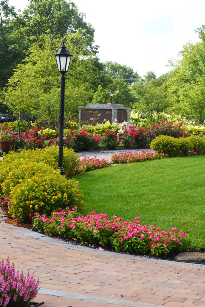 Brick walkway surrounded by planted flowers