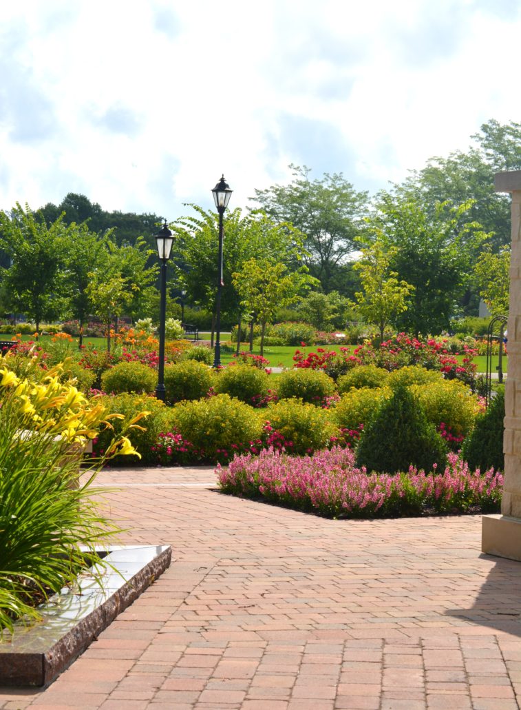 Brick path in park surrounded by flowers